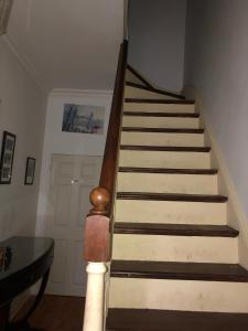 a set of stairs in a room with a door at Rectory Cottage in Croydon