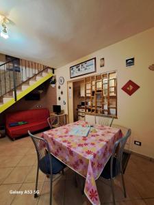 a dining room with a table and chairs and a staircase at B&B LA CASINA da SEMMY in Comacchio