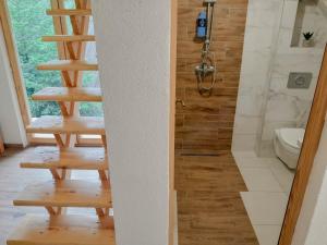 a bathroom with a staircase and a shower at Rafting Camp Encijan in Foča