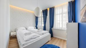 a small room with a bed with towels on it at Apartamenty Sun & Snow Karlikowo in Sopot