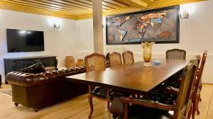 a dining room with a table and a leather couch at Quiet Abana in Abana