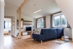 a living room with a blue couch and a tv at Riesenbauer in Zeutschach