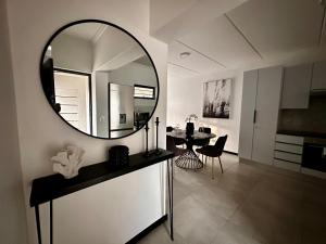 a large mirror on the wall of a living room at Stylish Executive Apartment with Power Backup in Johannesburg