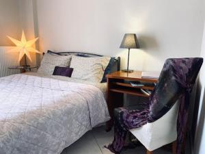a bedroom with a bed and a desk and a chair at Central Charming Apartment in Tripolis