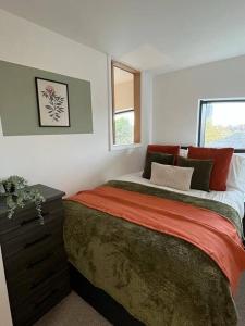 a bedroom with a large bed and a window at Skygardens - Stylish Central Duplex - Roof Garden in Manchester