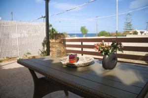 a black table with a vase of flowers on it at Xanthi's Summer House in Vathí