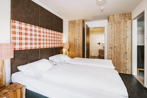 Łóżko lub łóżka w pokoju w obiekcie AvenidA Mountain Lodges Kaprun