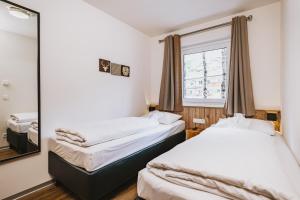 Łóżko lub łóżka w pokoju w obiekcie AvenidA Mountain Lodges Kaprun