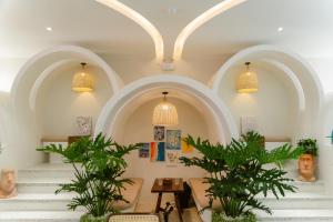 a lobby with stairs and potted plants at Lotus Home Cafe in Phú Quốc +48 photos