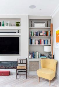 a living room with a tv and a chair and a fireplace at ALTIDO Spectacular house with private garden in London