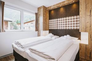 Łóżko lub łóżka w pokoju w obiekcie AvenidA Mountain Lodges Kaprun