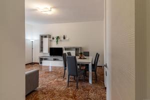 a dining room with a table and chairs at Fiera di Ferrara Huge Apartment x7! in Ferrara