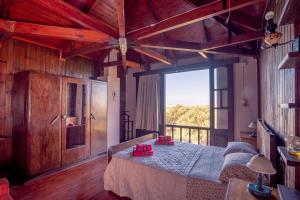 a bedroom with a bed and a large window at Rustic Retreat in Tílisos