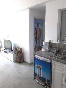 a kitchen with a statue in the corner of a room at Attalos luxury flat Psyrri square in Athens