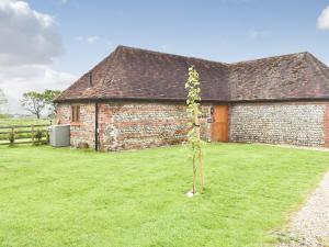 a tree in front of a brick building at The Cow Shed in Hooe