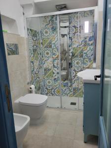 a bathroom with a shower and a toilet and a sink at Nonna Libera Vista Mare in Rodi Garganico