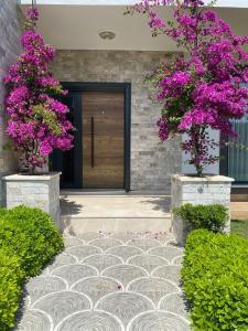 a front door of a house with purple flowers at Villa Kalinda close to Dalaman Airport in Dalaman
