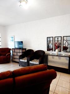 a living room with a couch and chairs at OCEAN VIEW, DOLPHIN BAY 19 ASTON BAY in Jeffreys Bay