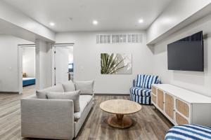 a living room with a couch and a tv at Seaport Suites in Wildwood