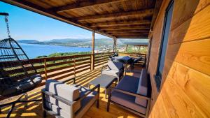 a balcony with chairs and a view of the water at Luxury Mobile Homes - Adria Superior in Klenovica