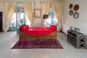 a bedroom with a large red bed in a room at La Boheme in Taormina