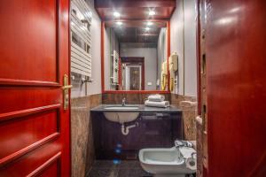 a bathroom with a sink and a toilet at Castro Pretorio 64 Easy Rooms in Rome