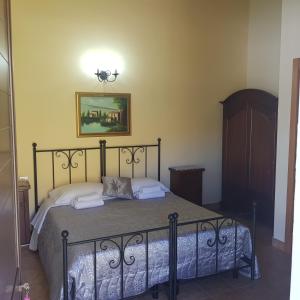 a bedroom with a bed with a picture on the wall at Terra Nostra in Cattolica Eraclea