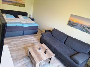 a living room with a couch and a bed at Ostwind in Hohenfelde