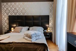Ein Bett oder Betten in einem Zimmer der Unterkunft Atmosfere Milano Marittima