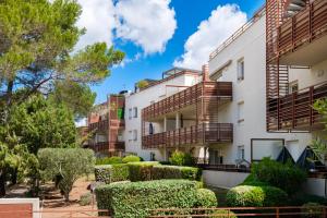 an apartment building with balconies and bushes at Natura Parc Toit Terrasse in Fréjus