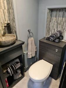 a bathroom with a white toilet and a sink at CARAMBOLA LUXURY AIR BNB IN THE HEART OF BEVERLEY in Beverley