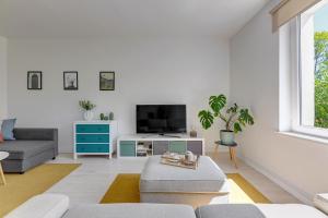 a living room with a couch and a tv at Downtown Apartments Angielska Grobla Street in Gdańsk