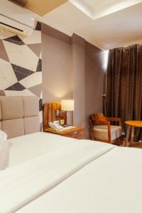 מיטה או מיטות בחדר ב-Tanga Beach Resort & Spa