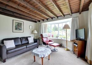 a living room with a couch and a tv at Rockley Cottage in Egton