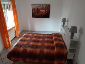 a bedroom with a large bed with a brown blanket at Case Gemelle - CIR 0271 in Aosta