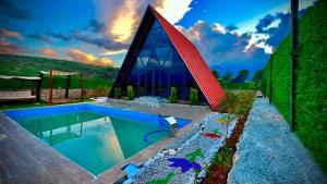 a house with a swimming pool and a building at villa hidden paradise garden in Fethiye