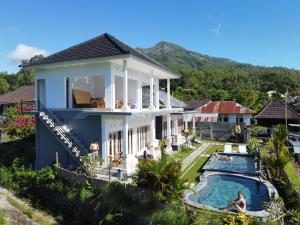 an aerial view of a house with a swimming pool at Batur Pyramid Guesthouse in Kintamani