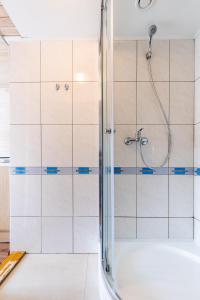 a shower with a glass door in a bathroom at Kopų 32 Šventoji in Šventoji