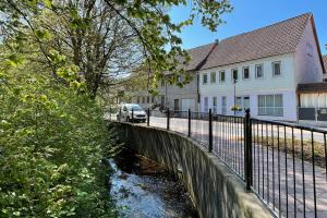 a bridge over a river in front of a house at Ferienwohnung Eliese in Suhl in Suhl