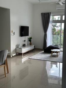 a white living room with a tv and a couch at Duck Duck House 3BR 7-11 PAX in Johor Bahru
