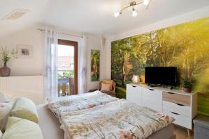 a bedroom with a bed and a flat screen tv at Mutschler in Freudenstadt