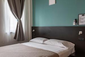Postel nebo postele na pokoji v ubytování Il B&B di PIAZZA MOTTA