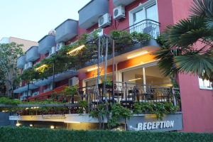 a building with plants on the side of it at Avalon otel in Kusadası