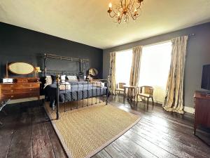 a bedroom with a bed and a mirror and a table at Ann's Hill in Cockermouth