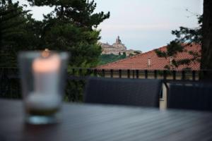 a candle on a table with a view of a building at Best Western Hotel I Colli in Macerata