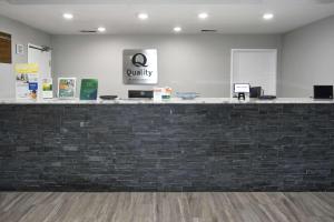 a cashier counter in a lobby with a brick wall at Quality Inn & Suites Brooks Louisville South in Brooks +40 photos
