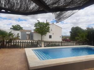 a swimming pool in front of a house at Casa Rural Casa Máxima in Yecla