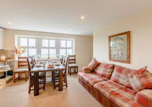 a living room with a couch and a table at Vale View in Glanton