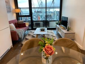 a living room with a table with a vase of flowers at Apartment with nice view in Boxhill 8A in Box Hill