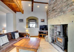 a living room with a couch and a fireplace at Boca Chica Cottage in Cambois
